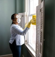 Photo by CDC Limpieza Abella La Coruña woman in white long sleeve shirt and blue denim jeans standing beside white wooden framed glass